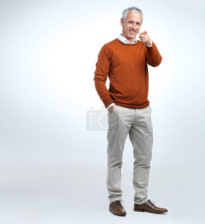 Photo for Portrait, mature man and finger pointing in studio with mockup, smile and happiness in white background. Fashion, formal and professional outfit for trendy, cool and retro style for senior person. - Royalty Free Image
