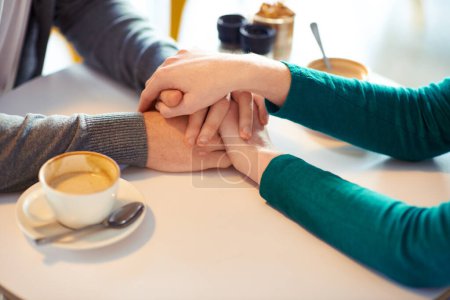 Photo for Holding hands, couple and coffee in cafe with love, romance and affection on anniversary date. Respect, together with care and bonding, loyalty and support in relationship with cappuccino for people. - Royalty Free Image