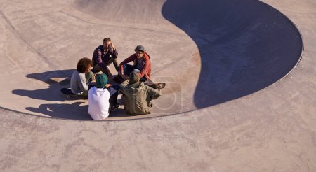 Photo for Group, skate park and friends with conversation, relax and sunshine with weekend break and team. People, outdoor and skaters with summer and recreation with diversity and support with discussion. - Royalty Free Image
