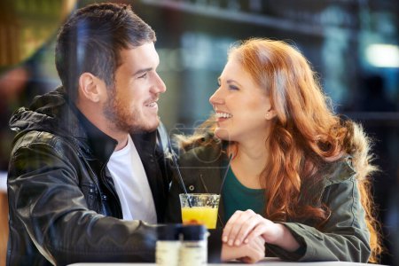 Photo for Look, happy and couple in restaurant for care on date for relationship anniversary with commitment, support and trust. Man, woman and in love together, hand holding and affection in cafe for bonding - Royalty Free Image