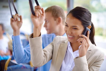 Photo for Business people, transport and phone call on bus, smile and hand strap for urban commute. Technology, communicating and cellphone for entrepreneur, professional and employee and happy while traveling. - Royalty Free Image