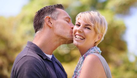 Photo for Portrait, couple and love with kiss in happiness on outdoor, affection and romance with date. Park, relationship and together with smile for bonding, care and trust with commitment for support. - Royalty Free Image