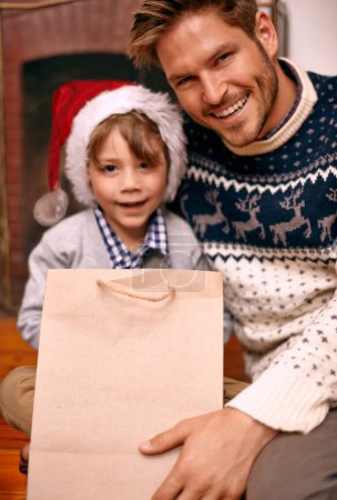 Photo for Portrait, father and son with smile for Christmas gift in house, hat and boy with happiness for holiday. Man, relax and parent to child in apartment for celebration of festive season in home. - Royalty Free Image