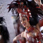 Happy, dancer and samba for carnival and music festival or night performance with costume and band. Woman, dancing and drums for event, celebration and culture or history in Rio de Janeiro, Brazil.