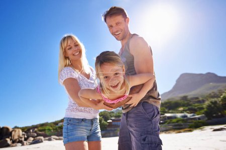 Photo for Parents, swing and playing with girl at beach in portrait with care, love and bonding in summer on holiday. Father, mother and daughter with games, connection and seaside with sunshine on vacation. - Royalty Free Image