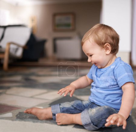 Photo for Growth, development and childhood for toddler in lounge for play and curiosity on floor. Baby, infant or kid at home with smiles and sitting with laugh and happiness for adorable and indoors. - Royalty Free Image