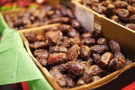 Photo for Harvest, natural and bunch of organic dates for nutrition, health and wellness diet snack. Sustainable, farmers market and dried fruit for vitamins, digestion or fiber on display in grocery store - Royalty Free Image