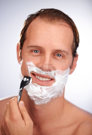 Photo for Man, portrait and shaving cream with razor for beard hair removal or grooming, maintenance or white background. Male person, face and smile with tool for dermatology cleaning, studio or mockup space. - Royalty Free Image