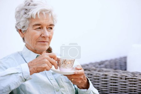 Photo for Senior, woman and thinking with cup for retirement, relaxing on patio in peace enjoying wellness retreat and pension. Elderly person, plan activities and drinking tea with reflection and nostalgia. - Royalty Free Image