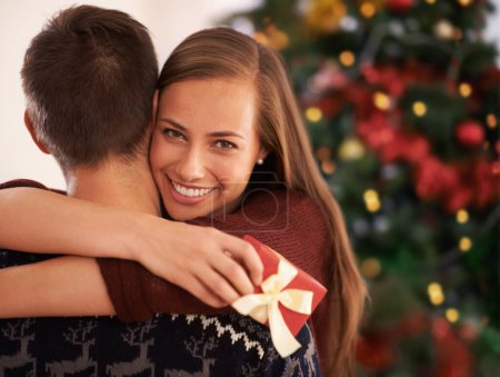 Photo for Gift, hug and couple with portrait, Christmas and festive season with marriage and holiday. Love, embrace and man with woman and vacation with Xmas and celebration with relationship, home and present. - Royalty Free Image