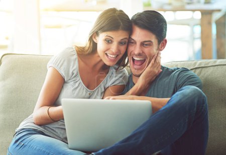 Photo for Excited couple, laptop and sofa with hug for good news, winning or giveaway in living room at home. Happy man and woman with smile on computer in celebration for promotion, deal or discount at house. - Royalty Free Image