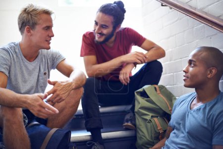 Photo for Happy man, student and friends talking on stairs with group for conversation, social interaction or chat at campus. University people or male person with smile on staircase for discussion at college. - Royalty Free Image
