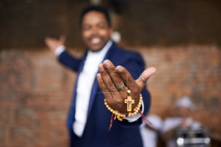 Photo for Black man, christianity and hands with cross at church for holy welcome, faith or hope of spiritual leader. Closeup of African male person, priest or preacher with rosary beads for worship of god. - Royalty Free Image