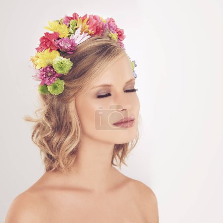 Photo for Woman, makeup and flowers on crown in studio with face and confidence for cosmetics, beauty and skincare. Spring aesthetic, model and floral headband with mockup space or wellness on white background. - Royalty Free Image