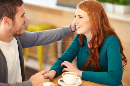 Photo for Couple, man and woman holding hands in cafe for love, support and happiness for peace in relationship. Adult, male person and guy caress girl or partner with hand in coffee shop with smile and joy. - Royalty Free Image
