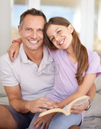 Photo for Father, girl and book on sofa for portrait with hug, care and connection in family home with reading. Dad, child and happy together on couch with teaching, education and embrace for bonding in house. - Royalty Free Image