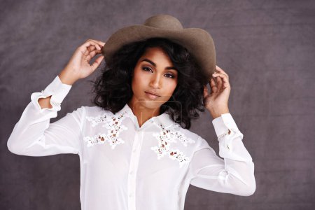 Photo for Portrait, studio and woman with cowboy fashion, confidence and relax with girl in stetson hat. Rodeo, western style and face Mexican model with cowgirl culture, wild west clothes and grey background. - Royalty Free Image