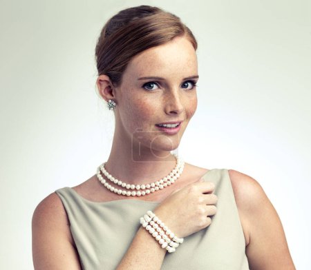 Photo for Portrait, fashion and beauty of woman with pearls in studio isolated on a gray background. Face, freckles and young person in vintage clothes for style, retro or elegance with necklace in Ireland. - Royalty Free Image