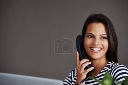 Photo for Telephone call, smile and business woman in conversation, talking or listening to contact in startup office. Landline, happy and secretary on phone, receptionist and creative person with mockup space. - Royalty Free Image