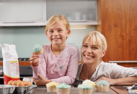 Photo for Happy, mom and child with cupcake in kitchen and learning about baking together in home to relax. Family, bonding and kid smile with mother, excited for eating cake, sweets or enjoy food in house. - Royalty Free Image