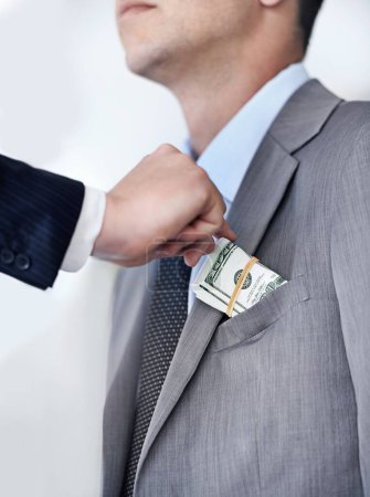 Photo for Businessman, hands and bribe with money for fraud, payment or deal on a white studio background. Closeup of man or employee taking cash, dollar bill or paper in scam, secret or bribery from colleague. - Royalty Free Image