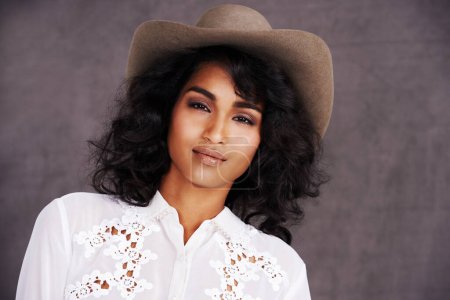 Photo for Portrait, studio and woman with cowgirl fashion, confidence and relax with girl in stetson hat. Rodeo, western style and face Mexican model with cowboy culture, wild west clothes and grey background. - Royalty Free Image