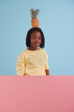 Photo for Portrait, banner or boy child with pineapple in studio for health, wellness or gut health on blue background, Fruit, balance or face of African teen model with organic diet poster, nutrition or detox. - Royalty Free Image