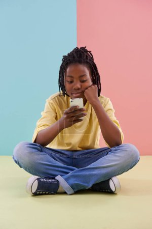 Photo for Search, phone and bored boy child on a floor with social media, reading or ebook in his home. Smartphone, lazy or African teen with app for Netflix and chill sign up, google or or watching video. - Royalty Free Image