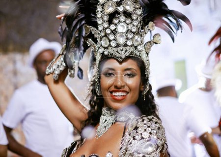 Photo for Portrait, happy woman and dancer at carnival with band for performance, party or celebration. Face, samba and Brazilian person at music festival in feather costume, makeup and smile at concert event. - Royalty Free Image