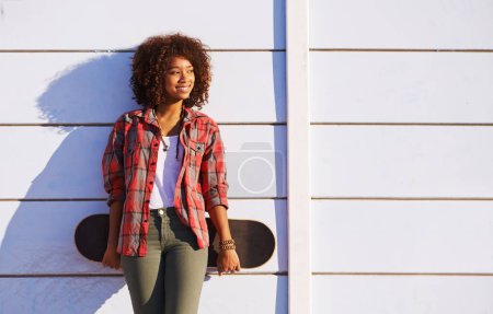 Photo for Skateboard, fashion and black woman in skatepark for exercise, training and skating in city. Skater, smile and happy female person for trendy, edgy style and hipster clothing in San Francisco. - Royalty Free Image