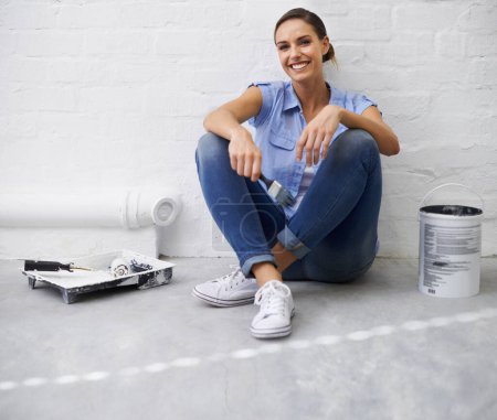 Photo for Woman, portrait and brush for paint in home, remodeling and maintenance in apartment. Happy female person, floor and equipment for interior upgrade, diy and tool for house repairs or renovation. - Royalty Free Image