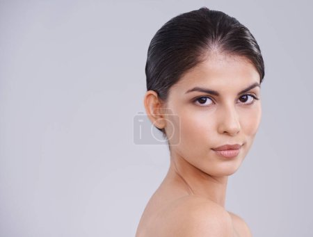 Photo for Face, beauty and skincare with woman in studio, clean and natural with cosmetic care and wellness on grey background. Facial, treatment and dermatology with model in portrait, healthy skin and shine. - Royalty Free Image