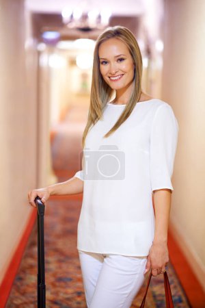 Photo for Luggage, travel and portrait of woman in hotel for holiday, vacation and weekend in accommodation. Happy, fashion style and person with bag in resort, lodge or room for journey, trip and adventure. - Royalty Free Image