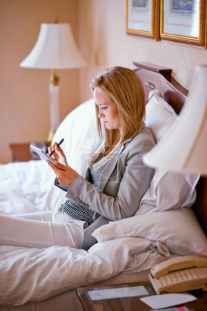 Photo for Business, woman and technology on bed with planning for corporate research, digital tablet and work schedule. Professional, person and touchscreen for writing review notes or internet search in hotel. - Royalty Free Image