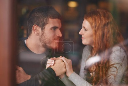Photo for Couple, smile and holding hands on date at cafe for bonding, romance and healthy relationship with relax. Man, woman or lens flare at coffee shop with happiness, trust or love on anniversary vacation. - Royalty Free Image