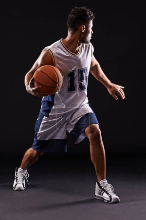 Photo for Man, action and basketball player in studio for sports, competition and fitness on black background. Professional athlete, career and exercise with ball for game, hobby and healthy model in training. - Royalty Free Image