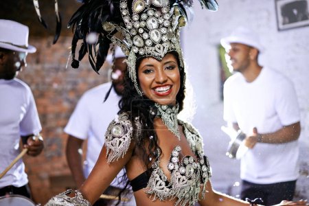 Photo for Portrait, happy woman and dancing at carnival with band for performance, party or celebration. Face, samba and Brazilian person at music festival in feather costume, makeup and smile at concert event. - Royalty Free Image