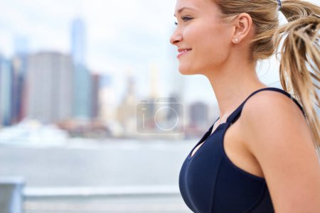 Photo for Woman, determined and running for fitness in city, jogging active and fit female person exercising in New York. Energy, marathon for sports training and workout for athlete, cardio for endurance. - Royalty Free Image