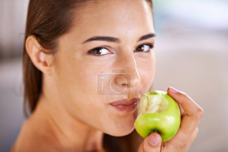 Photo for Woman, portrait and apple for nutrition in home, organic fiber and fruit for wellness. Happy female person, vitamins and minerals for healthy living, eating snack and vegan food in closeup for diet. - Royalty Free Image