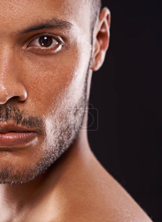 Photo for Skincare, man and half portrait in studio zoom for wellness, dermatology or skin cleaning on black background. Face, water and male model with masculine beauty, cosmetics or facial splash treatment. - Royalty Free Image