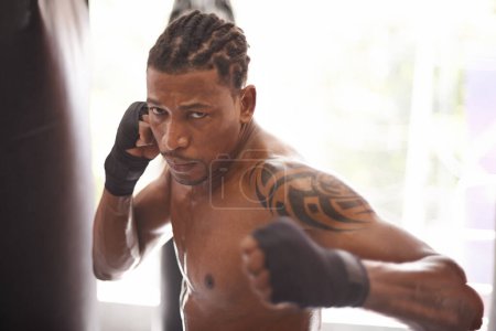 Photo for Boxing, portrait and black man with punch in gym for fitness challenge, fight and competition training. Power, muscle and serious face of champion boxer at workout with confidence in sports club - Royalty Free Image