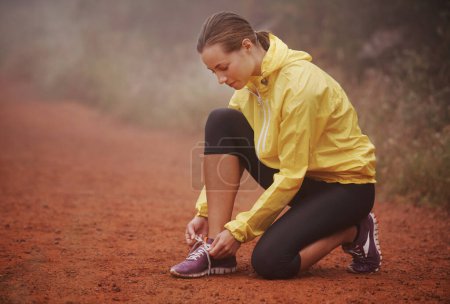 Photo for Running, shoelace and fitness woman in park for training, exercise or wellness in winter. Workout, sneakers or runner in nature for morning cardio preparation, sports or shoes check for marathon run. - Royalty Free Image