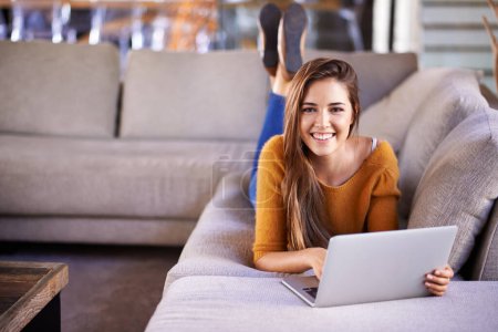 Photo for Happy, home and woman with a laptop, portrait and connection with typing in a lounge. Person on a sofa, apartment and girl with a computer and research with online blog and news with smile and relax. - Royalty Free Image