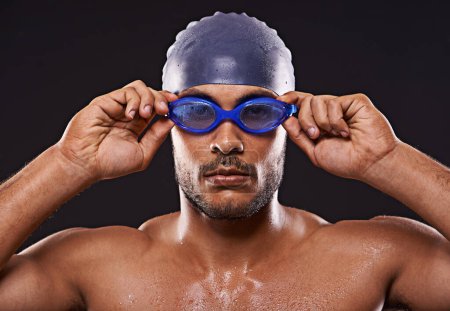 Photo for Studio, swimmer and man with goggles for sport and workout for training and exercise for body. Athlete, adult and male person with strength, professional and champion for career in black background. - Royalty Free Image