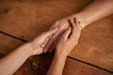 Photo for Closeup, people and hands with empathy or support for grief, comfort and compassion by table in home. Sympathy, family and praying together for gratitude, healing and kindness with trust and care. - Royalty Free Image