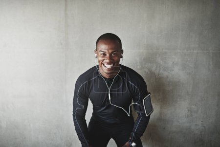 Photo for Man, portrait and earphones for fitness outdoor with listening, podcast or exercise for healthy body with mockup. Athlete, african person or arm pouch with phone for music, radio or happy for workout. - Royalty Free Image