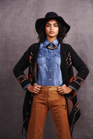 Photo for Fashion, cowgirl or woman confidence in portrait, studio and cool culture or clothing on grey background. Native American person, western and stylish model with pride, boho style and hands on hips. - Royalty Free Image