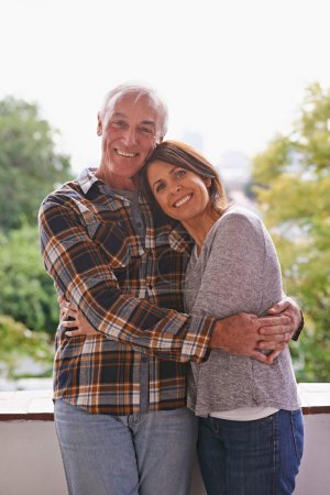 Photo for Senior couple, happy and portrait on balcony with hug, love and outdoor with connection for retirement. Woman, elderly man and embrace on patio with pride, care and smile at apartment in Germany. - Royalty Free Image