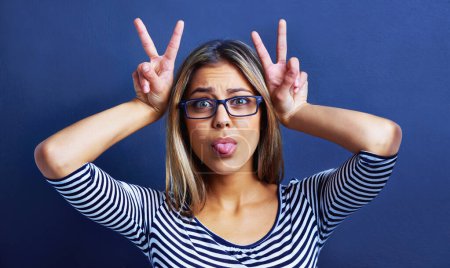 Photo for Studio, funny faces and woman with peace sign on hands for promo or deal for clothes in fashion. Adult, female person and girl in blue background with glasses or eyewear, aesthetic and portrait. - Royalty Free Image