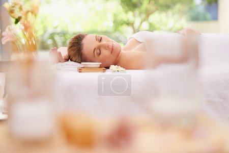 Photo for Woman, relax and sleeping with towel at spa in stress relief, zen or health and wellness on massage table. Calm female person enjoying luxury skincare, body treatment or relaxation at peaceful resort. - Royalty Free Image